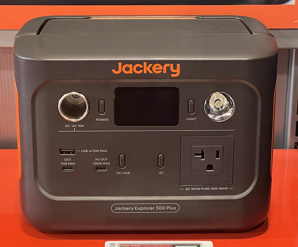 A dark gray Jackery Explorer 300 Plus power station with a display, USB ports and an AC outlet on the front, for storm prep in Marion, IA