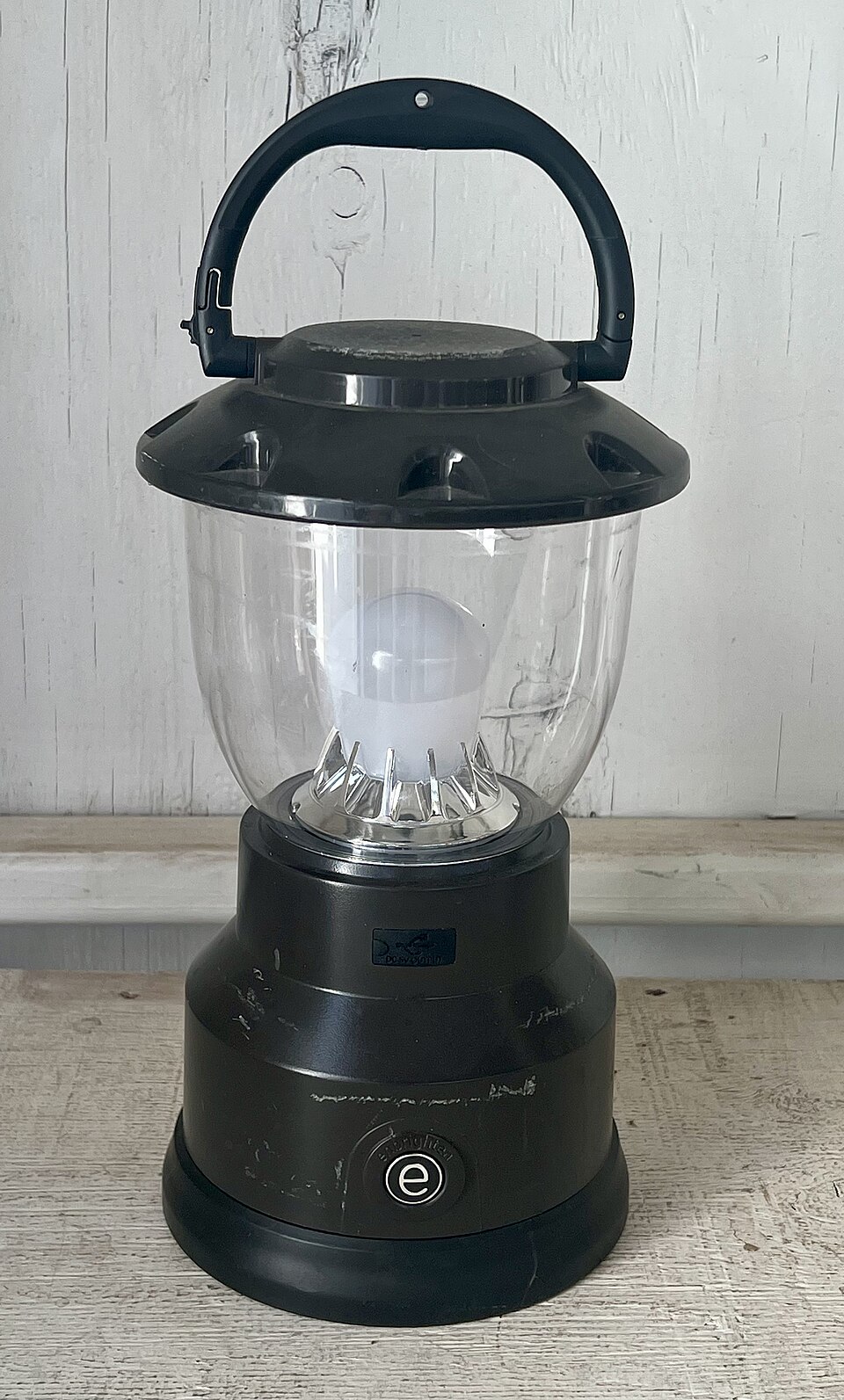 A black LED camping lantern with a clear globe and a top carry handle, for storm prep in Marion, IA