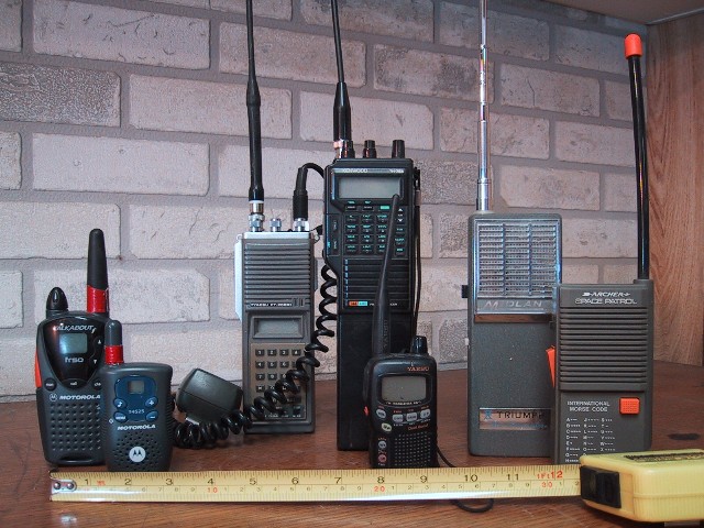 Several handheld walkie-talkies of different makes standing side by side, for storm prep in Marion, IA